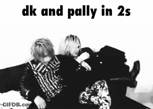 A Black And White Photo Of Two People Sitting On A Couch With The Caption " Dk And Palliy In 2S " GIF