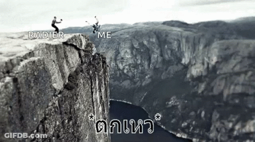 A Black And White Photo Of Two People Standing On Top Of A Mountain . GIF