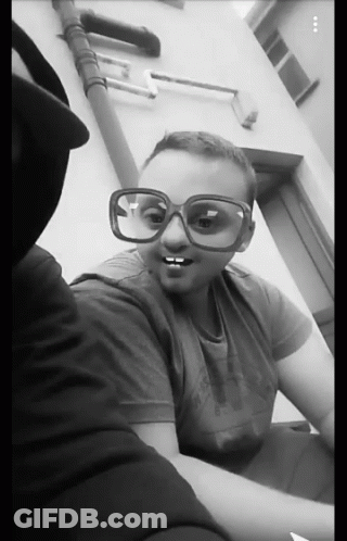 A Black And White Photo Of Two People Wearing Sunglasses GIF