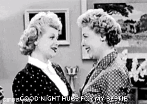 A Black And White Photo Of Two Women Hugging Each Other In A Room . GIF