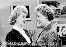 A Black And White Photo Of Two Women Hugging Each Other In A Room . GIF