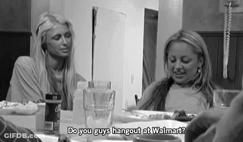 A Black And White Photo Of Two Women Sitting At A Table With The Words Do You Guys Hangout At Walmart GIF