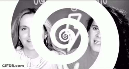 A Black And White Photo Of Two Women With A Spiral In The Background GIF