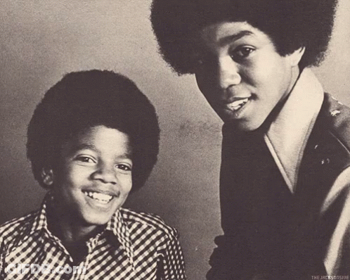 A Black And White Photo Of Two Young Men With The Caption " The Jacksonsue " On The Bottom GIF