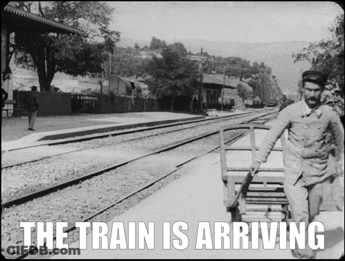 Black And White Photo Of Arriving Train GIF