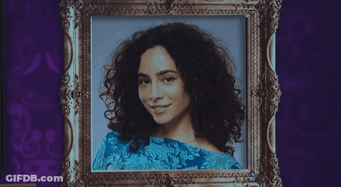 A Black And White Portrait Of A Woman With Curly Hair GIF