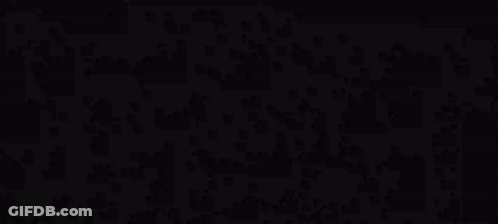 A Black And White Silhouette Of A Man Standing In A Dark Room . GIF