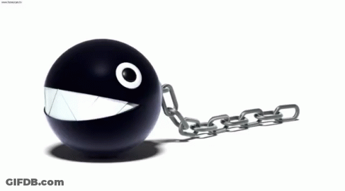 A Black Ball With A White Mouth And A Chain Attached To It GIF