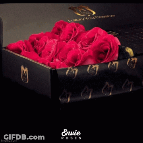 A Black Box Filled With Pink Roses Says Envie Roses On The Bottom GIF