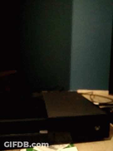 A Black Box Is Sitting On A Table In The Dark . GIF