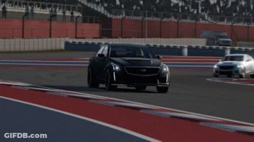 A Black Cadillac Is Driving On A Track GIF