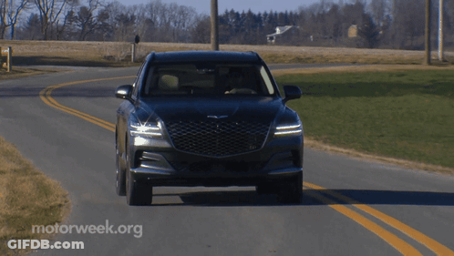 A Black Car Is Driving Down A Road With Motorweek.org Written In The Corner GIF