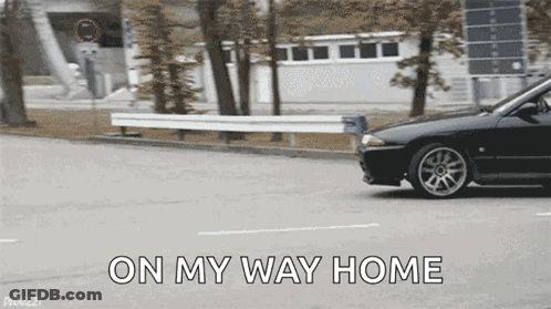 A Black Car Is Driving Down A Street With The Words On My Way Home Written On The Bottom GIF
