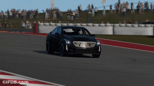 A Black Car Is Driving On A Race Track With A Crowd In The Background GIF
