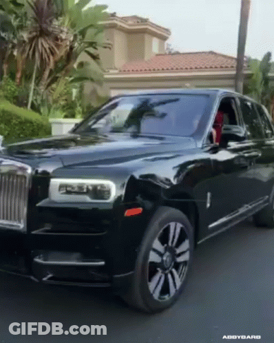 A Black Car Is Parked In Front Of A House GIF