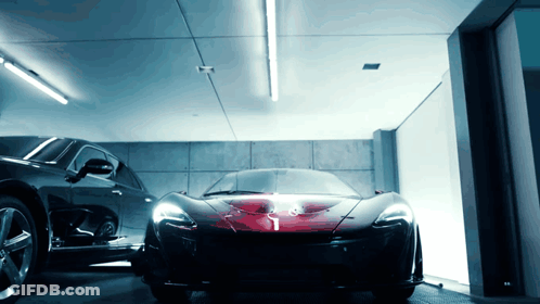A Black Car Is Parked Next To A Red Sports Car GIF