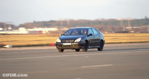 A Black Car With A License Plate That Says ' A ' On It Drives Down A Road GIF
