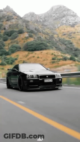 A Black Car With A License Plate That Says C342l4 Is Driving Down A Highway GIF