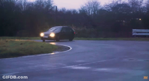 A Black Car With A License Plate That Says Lkd70 Is Driving Down A Wet Road GIF