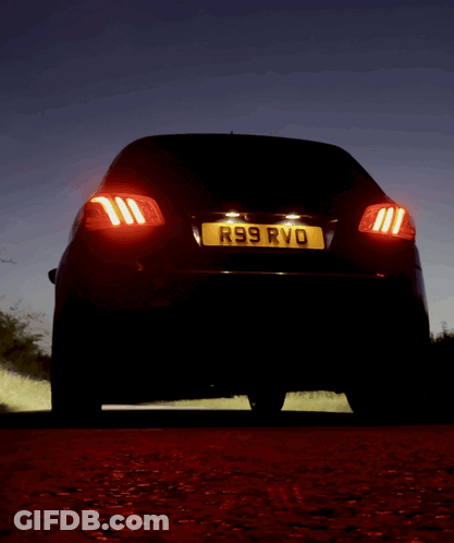 A Black Car With A License Plate That Says R99 Rvd GIF