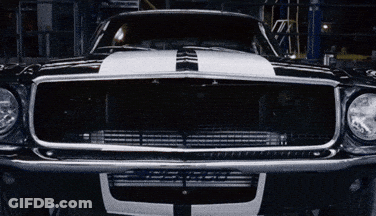 A Black Car With A White Stripe On The Hood GIF