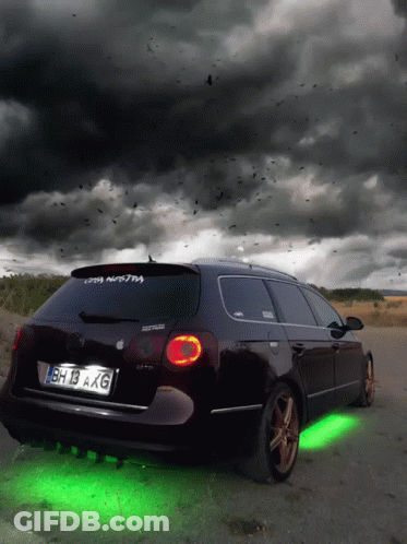 A Black Car With License Plate Bh 13 Axg Is Parked On The Side Of The Road GIF
