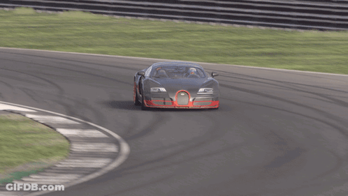 A Black Car With Red Wheels Is Driving On A Race Track GIF