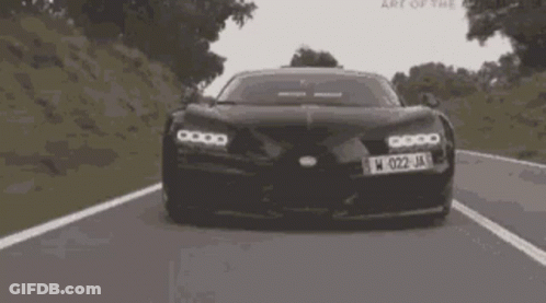 A Black Car With The License Plate W 022 Ja Is Driving Down A Road GIF