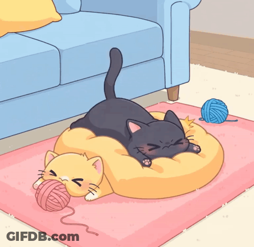 A Black Cat Laying On A Yellow Pillow Next To A Yellow Cat On A Pink Rug GIF