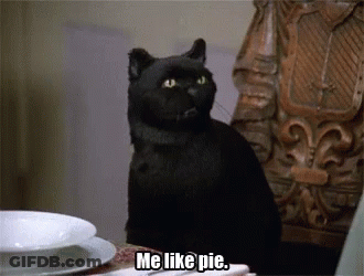 A Black Cat Sitting At A Table With The Words Me Like Pie Below It GIF