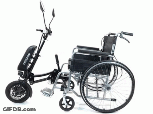 A Black Folding Electric Bike With Kenda Tires Is Parked On The Beach GIF