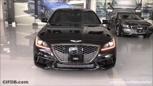 A Black G80 Is Parked In A Showroom GIF
