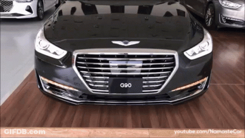 A Black G90 Car Is Parked On A Wooden Floor GIF