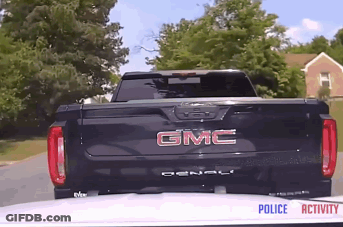 A Black Gmc Denali Truck Is Parked In Front Of A House GIF