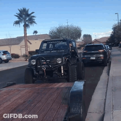 A Black Jeep With Asian Auto Parts On The Windshield GIF