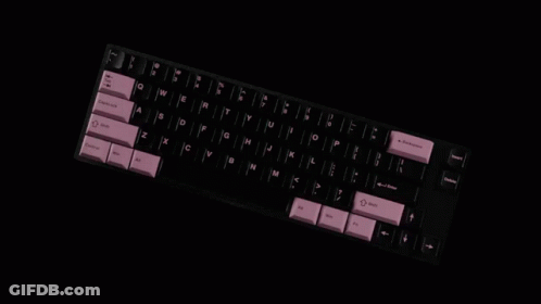 A Black Keyboard With Pink Keys Has The Shift Key On The Bottom Left GIF