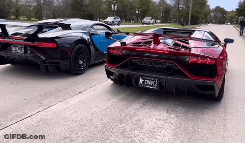 A Black Lamborghini Is Parked Next To A Red Lamborghini With A Texas License Plate GIF