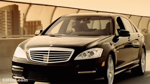 A Black Mercedes Is Parked On A Bridge GIF
