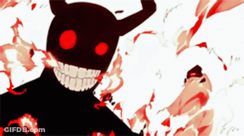 A Black Monster With Red Eyes And Horns Is Smiling GIF