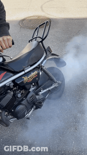 A Black Motorcycle With Meguiar 'S Written On The Side Of It GIF