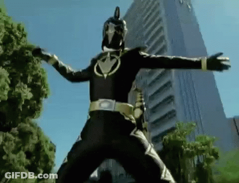 A Black Power Ranger Is Standing In Front Of A Tall Building . GIF