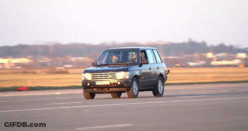 A Black Range Rover Is Driving Down A Road With A License Plate That Says Jc - Nc - 88 GIF