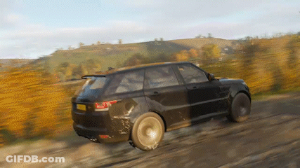A Black Range Rover Is Driving On A Dirt Road . GIF