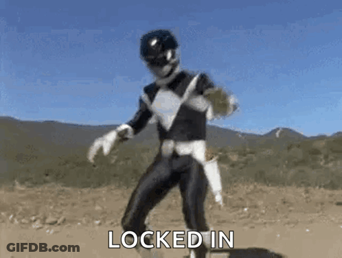 A Black Ranger From Power Rangers Is Dancing In The Dirt In Front Of Mountains . GIF