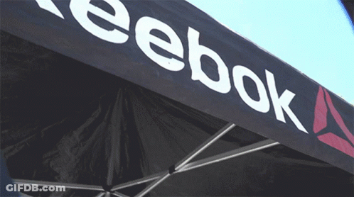 A Black Reebok Tent With A White Logo On It GIF
