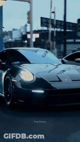 A Black Sports Car Is Driving Down A Street With The Words " Your Dream " On The Bottom GIF