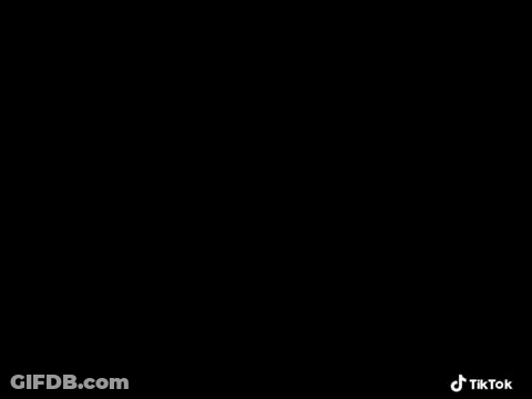 A Black Sports Car Is Parked In A Car Showroom . GIF
