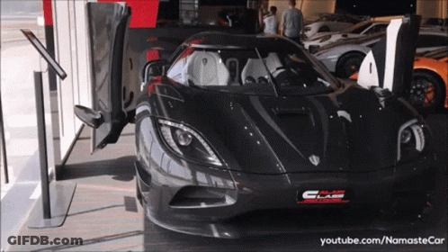 A Black Sports Car Is Parked In A Showroom With A Youtube.com Link GIF