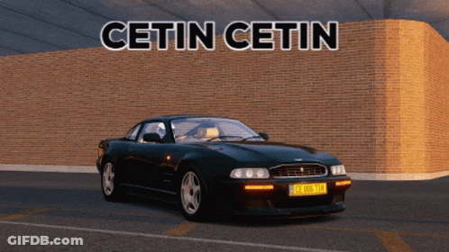 A Black Sports Car Is Parked In Front Of A Brick Wall With The Words Cetin Cetin Written Above It GIF