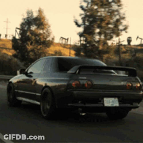 A Black Sports Car With A License Plate That Says ' Nzp ' On It GIF